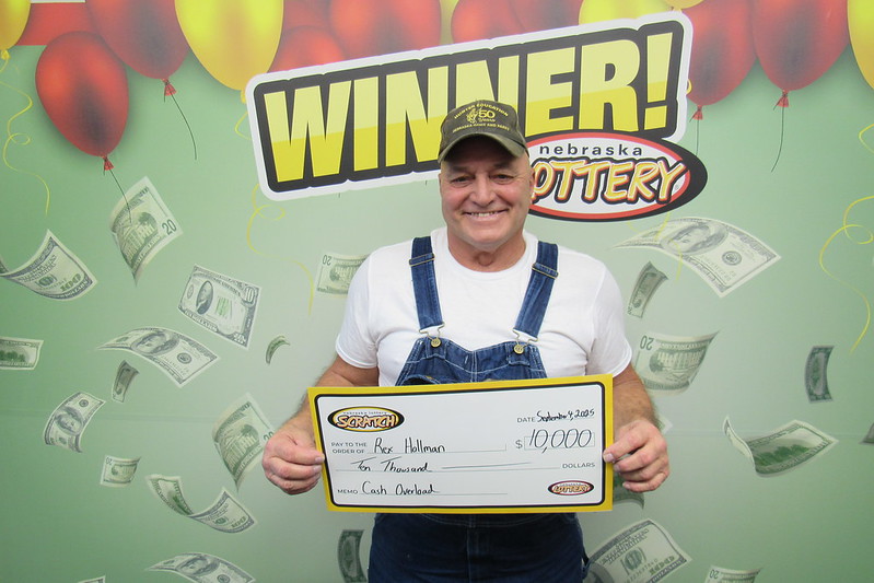 Photo of Rex Hollman of Crete with a check for $10,000.